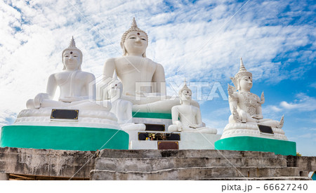 White Buddha on blue sky and cloud background White Buddha on blue sky and cloud background 66627240
