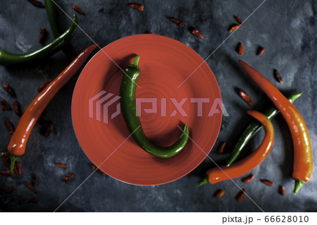 fresh spicy green pepper on red ceramic plate fresh spicy green pepper on red ceramic plate 66628010