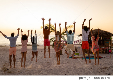Multi-ethnic group of male and female having fun on the beach 66630476