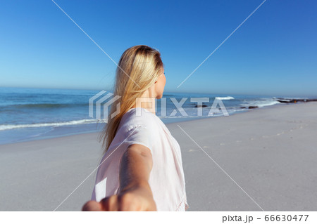 Caucasian woman enjoying at beach 66630477