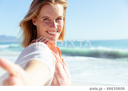 Caucasian woman enjoying time on the beach Caucasian woman enjoying time on the beach 66630606