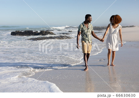 Happy couple spending time together on the beach Happy couple spending time together on the beach 66630630