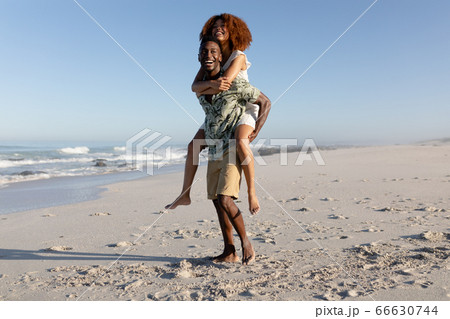 Happy couple spending time together on the beach Happy couple spending time together on the beach 66630744