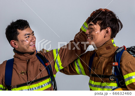 Asian male and female firefighter portrait, young smiling fireman in uniform 524 Asian male and female firefighter portrait, young smiling fireman in uniform 524 66632460