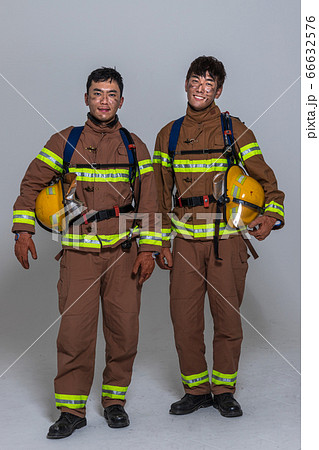 Asian male and female firefighter portrait, young smiling fireman in uniform 481 Asian male and female firefighter portrait, young smiling fireman in uniform 481 66632576