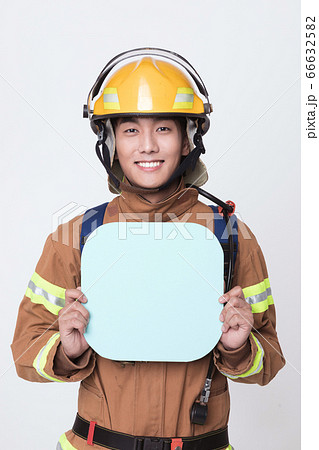 Asian male and female firefighter portrait, young smiling fireman in uniform 409 66632582
