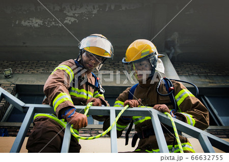 Asian male and female firefighter portrait, young smiling fireman in uniform 338 66632755