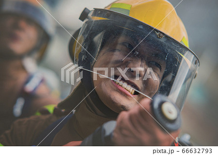 Asian male and female firefighter portrait, young smiling fireman in uniform 318 Asian male and female firefighter portrait, young smiling fireman in uniform 318 66632793