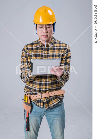 A studio portrait of Asian man making a confident smile 410 66633803