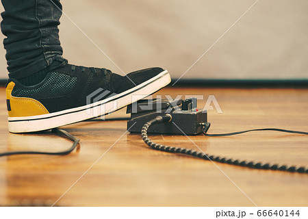Man using guitar effects pedal Man using guitar effects pedal 66640144