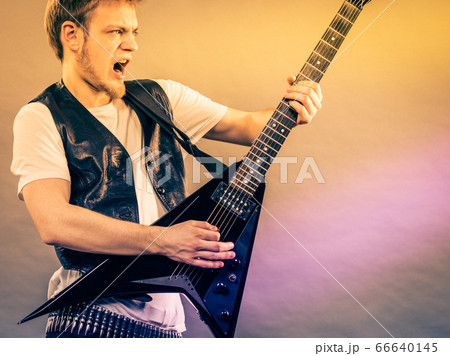 Young man playing electric guitar 66640145
