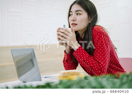 Woman working at home. Eating snack while working. Woman working at home. Eating snack while working. 66640410