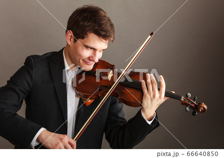 Man man dressed elegantly playing violin 66640850
