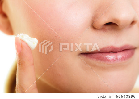 Skin care. Moisturizing cream on female finger 66640896