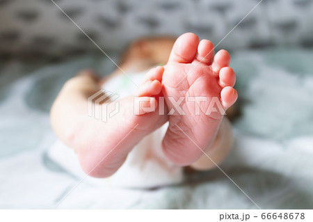 Close up pink newborn heels on bed. Close up pink newborn heels on bed. 66648678