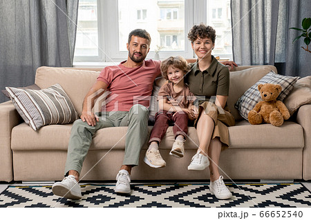 Happy young man, his pretty wife and their cute little son in casualwear 66652540