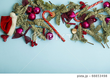christmass stuff laying flat on colorful background, branch of tree, balls, candy christmass stuff laying flat on colorful background, branch of tree, balls, candy 66653498