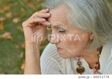 Portrait of sad, thoughtful senior woman in park Portrait of sad, thoughtful senior woman in park 66653778