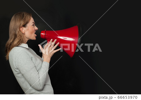Angry woman shouting with loudspeaker megaphone Angry woman shouting with loudspeaker megaphone 66653970