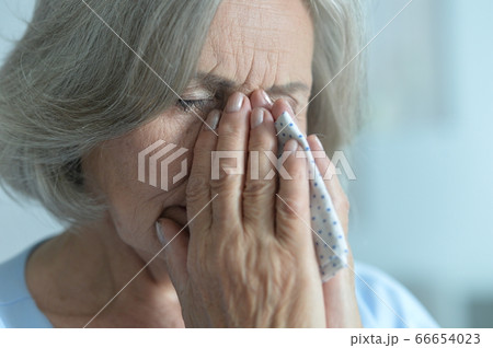 Portrait of sad senior woman at home 66654023