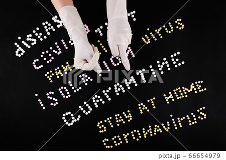 Two hands in medical gloves with fuck and fig gesture. Pandemic headline clipping words 66654979