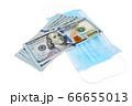 Blue medical face masks and stack of 100 USD banknotes 66655013