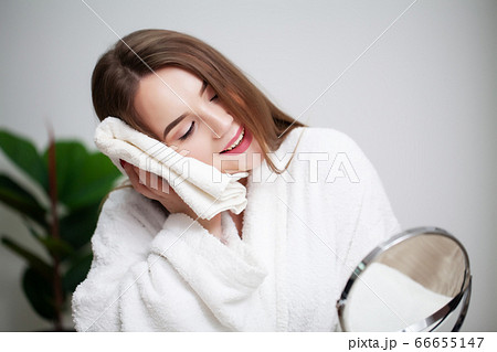 Cleansing facial skin, young woman holding white towel near facial skin after washing face Cleansing facial skin, young woman holding white towel near facial skin after washing face 66655147