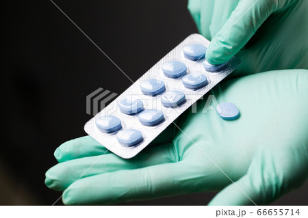 Doctor in gloves holds pills for men's sexual health 66655714