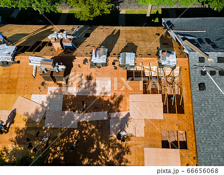 Roof repair, worker with replacing gray asphalt 66656068