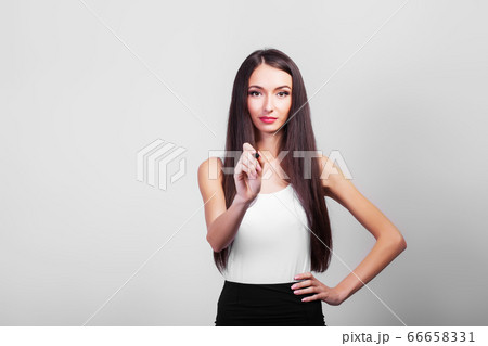 Cute businesswoman drawing with pen on virtual screen with copy space for text 66658331