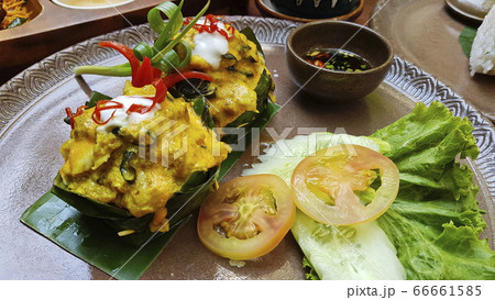 Famous traditional Cambodian Khmer delicacy, the Amok Fish. Vegetables and soya sauce. 66661585