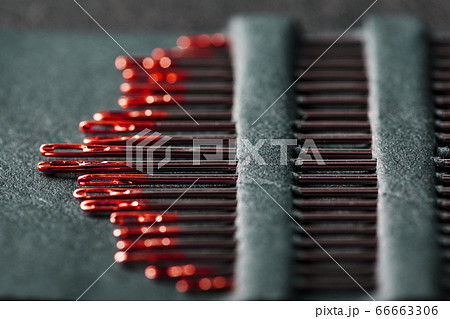 Sewing needles of different sizes in a set of red Sewing needles of different sizes in a set of red 66663306