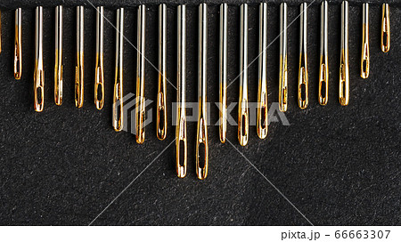 Set of Gold needles on a black background in a 66663307