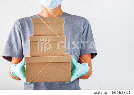 A delivery service employee holds a box with A delivery service employee holds a box with 66663311