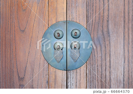 Ancient door handle on old wooden background Ancient door handle on old wooden background 66664370