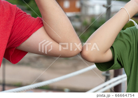 diverse man and young girl greeting bumping elbows 66664754