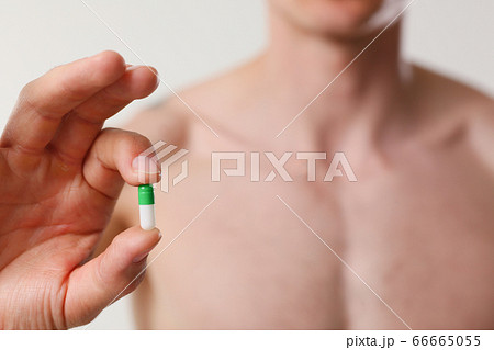 Athlete bodybuilder takes dope in the form of tablets form of pharma rapid progress in muscle development 66665055