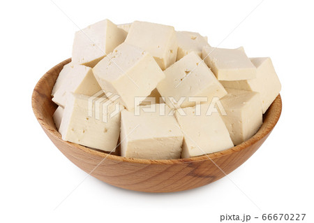 Heap of diced tofu cheese in wooden bowl isolated on white background with clipping path and full depth of field, Heap of diced tofu cheese in wooden bowl isolated on white background with clipping path and full depth of field, 66670227