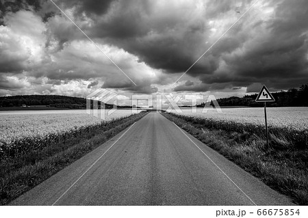 Amazing landscape in summer season, road sign indicating a bend 66675854