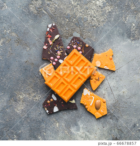 Chocolate bright orange fruit whole tile decorated with slices fruit nuts and slices on a gray background. Minimization Chocolate bright orange fruit whole tile decorated with slices fruit nuts and slices on a gray background. Minimization 66678857