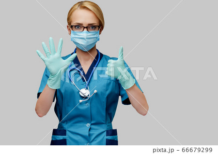 medical doctor nurse woman with stethoscope wearing protective mask and rubber or latex gloves showing at herself medical doctor nurse woman with stethoscope wearing protective mask and rubber or latex gloves showing at herself 66679299