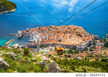 Old town of Dubrovnik with cable car ascending Srt mountain, Croatia 66684532