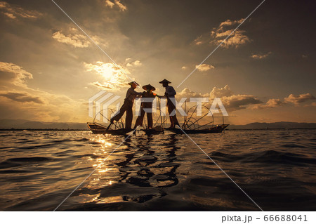 Intha Burmese fishermen on boat catching fish traditional at Inle Lake, Shan State, Myanmar Intha Burmese fishermen on boat catching fish traditional at Inle Lake, Shan State, Myanmar 66688041