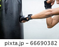 The man hit to bag on boxing training, he has 66690382