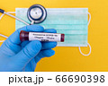 Hand holds a test tube containing a blood sample that has no the result positive or negative for coronavirus. 66690398