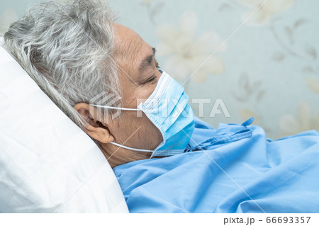 Asian senior woman patient wearing a face mask in hospital for protect safety infection Coronavirus Asian senior woman patient wearing a face mask in hospital for protect safety infection Coronavirus 66693357