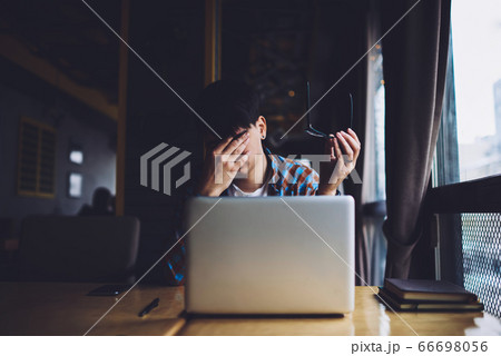 Portrait of positive smart student in trendy eyeglasses with black frame 66698056