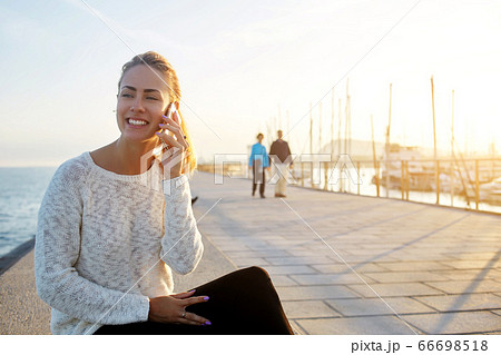 Smiling female lawyer is talking on mobile phone about her winning trial 66698518