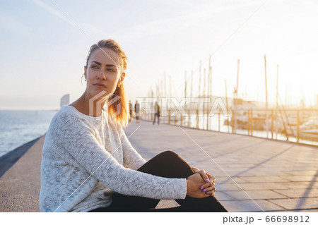 Cute hipster girl dreams about something and relaxes in the fresh air in her weekend 66698912