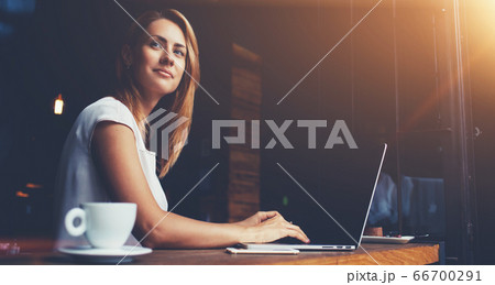 Charming happy woman student using laptop computer to prepare for the course work Charming happy woman student using laptop computer to prepare for the course work 66700291